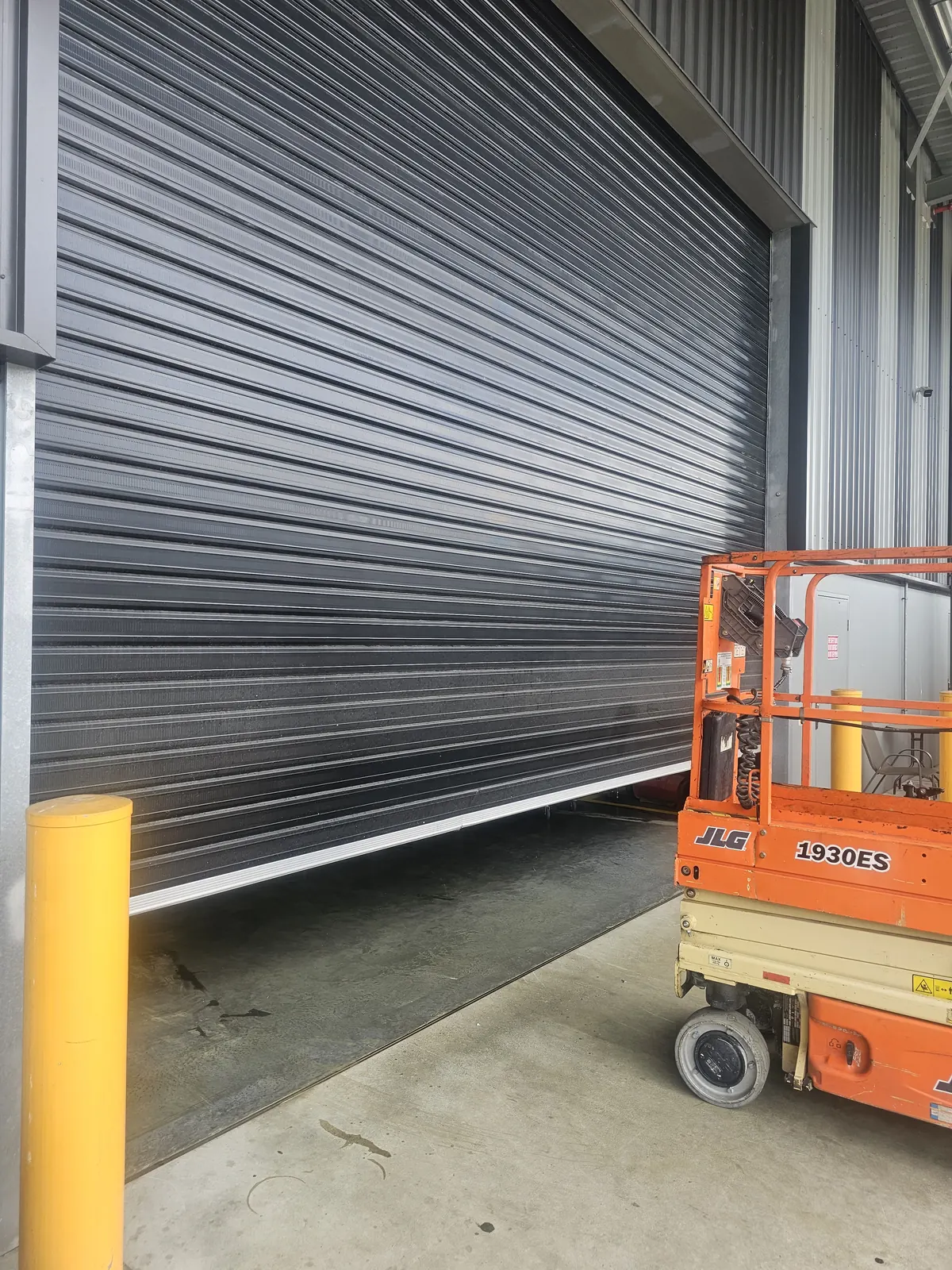 Industrial roller door service and scissor lift at a commercial property by On Call Doors